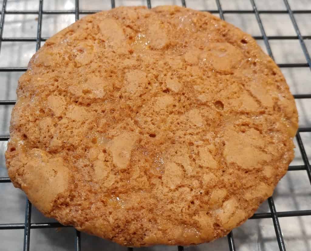 A finished toffee cookie cooling on a cooling rack so it gets crunchy 