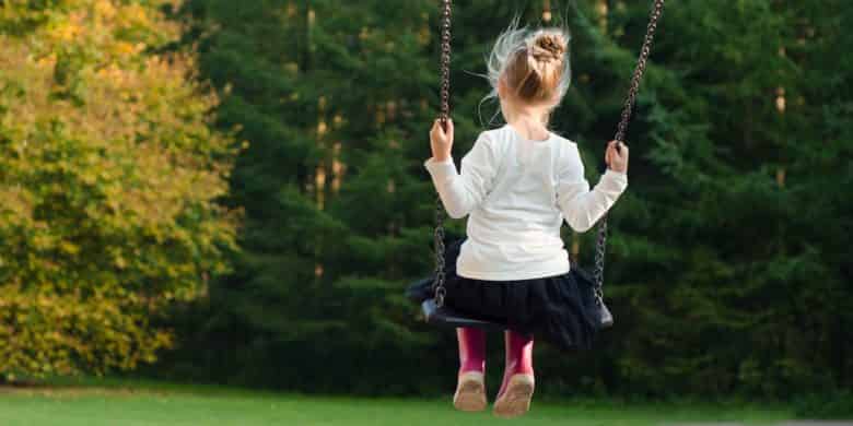 Introverted child alone on a swing