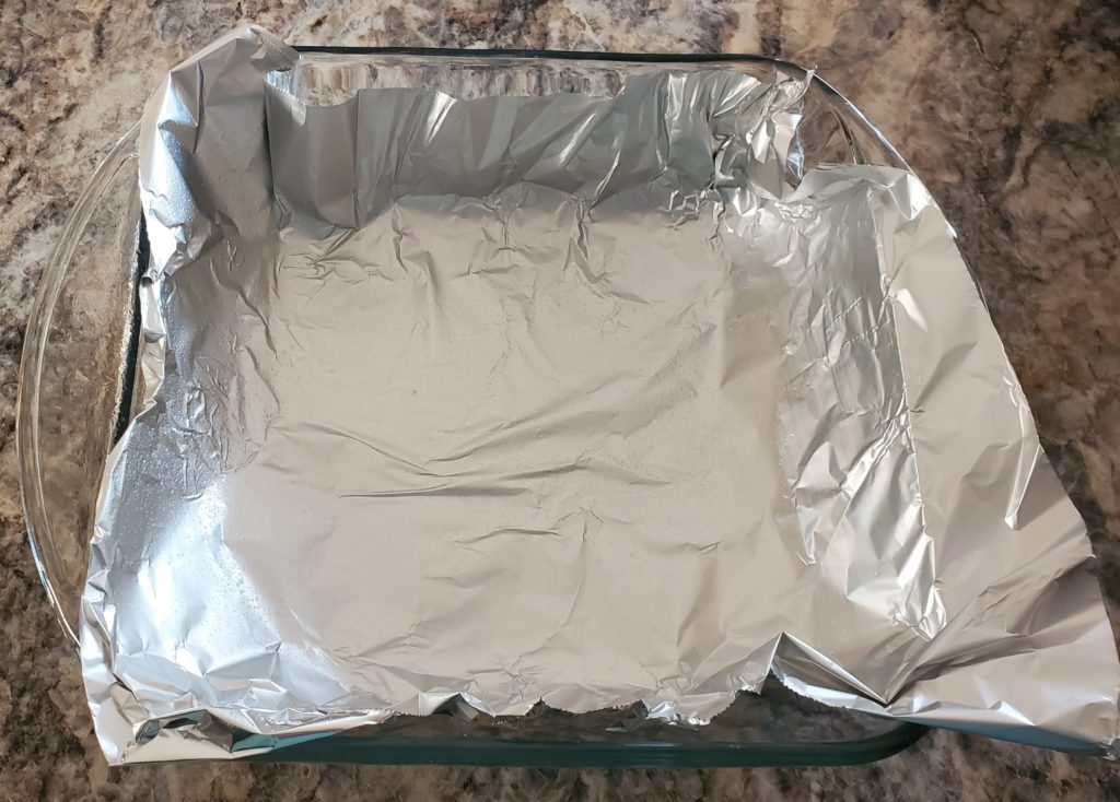 9x9 glass baking dish lined with aluminum foil that's been spritzed with non-stick cooking spray