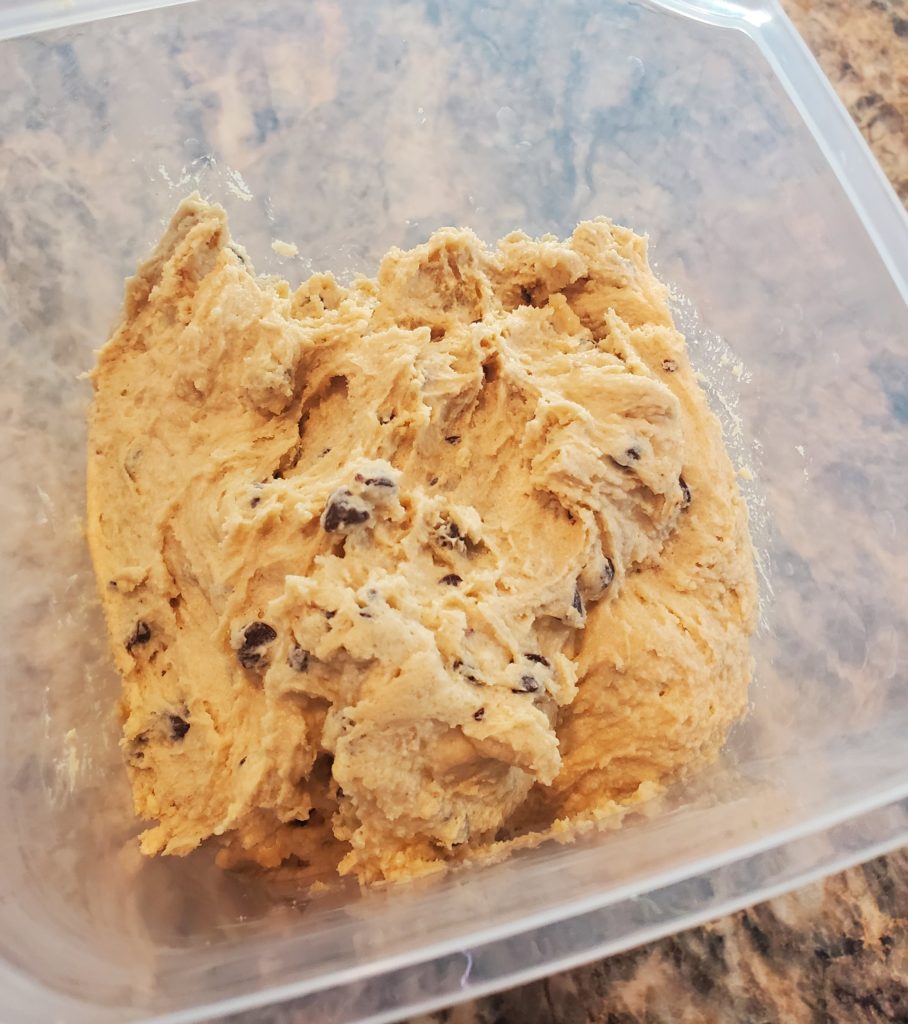 The edible chocolate chip cookie dough in an airtight container ready to go into the fridge