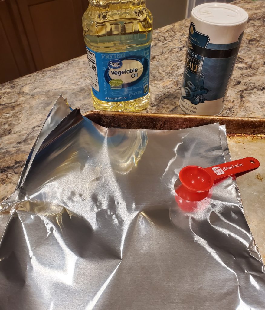 Set up to move the baked potatoes from the microwave to the oven with a baking sheet, aluminum foil sheets, vegetable oil with a tablespoon and coarse sea salt