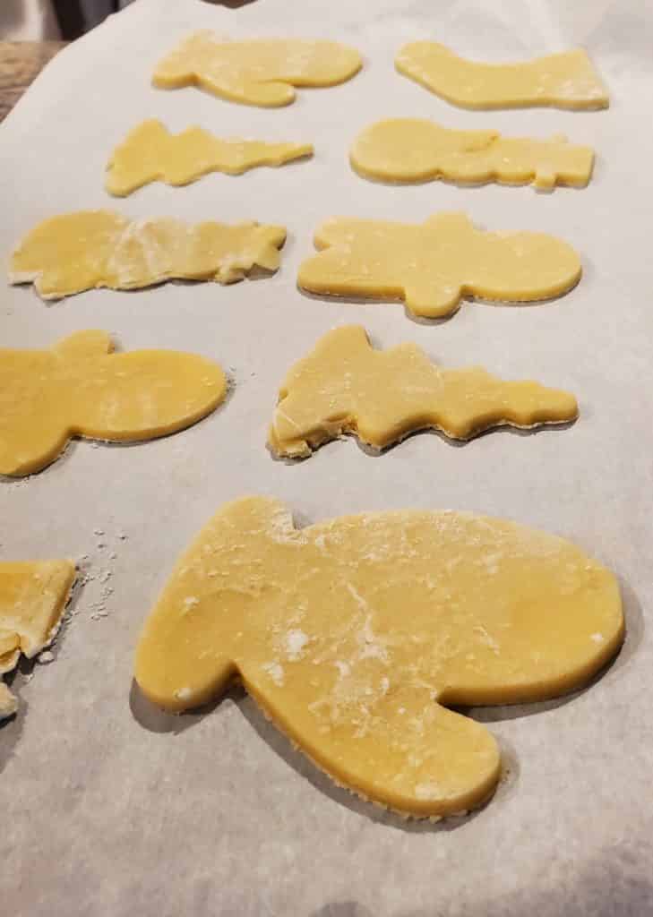 The cut out sugar cookies on a baking sheet, ready to go into the oven