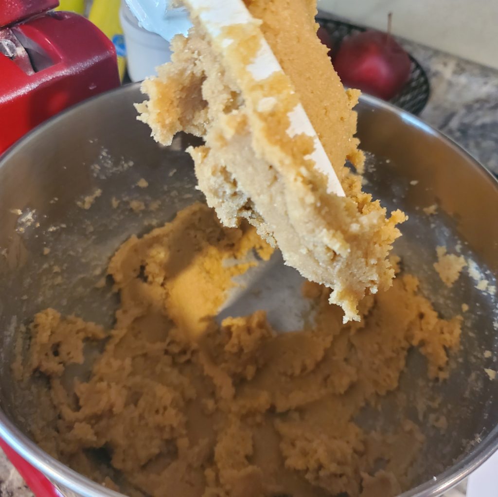 The creamed butter and brown sugar in the mixing bowl