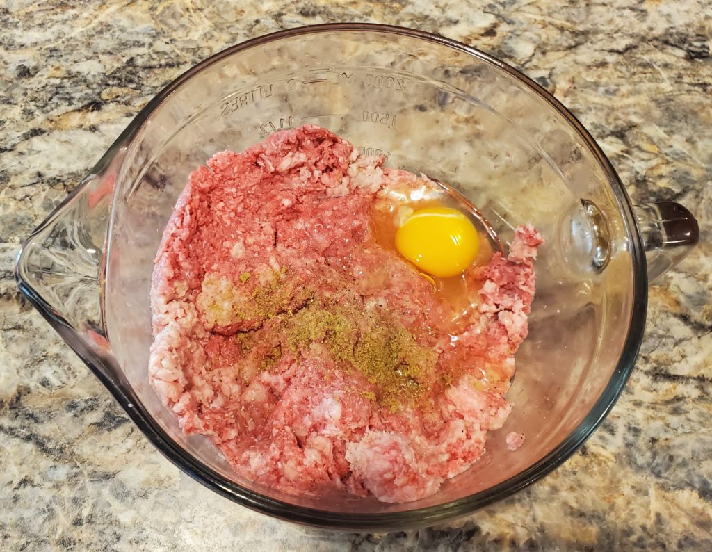The meatloaf ingredients (minus the glaze ingredients) in a large mixing bowl ready to be combined