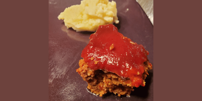 Meatloaf with ketchup glaze and a side of mashed potatoes