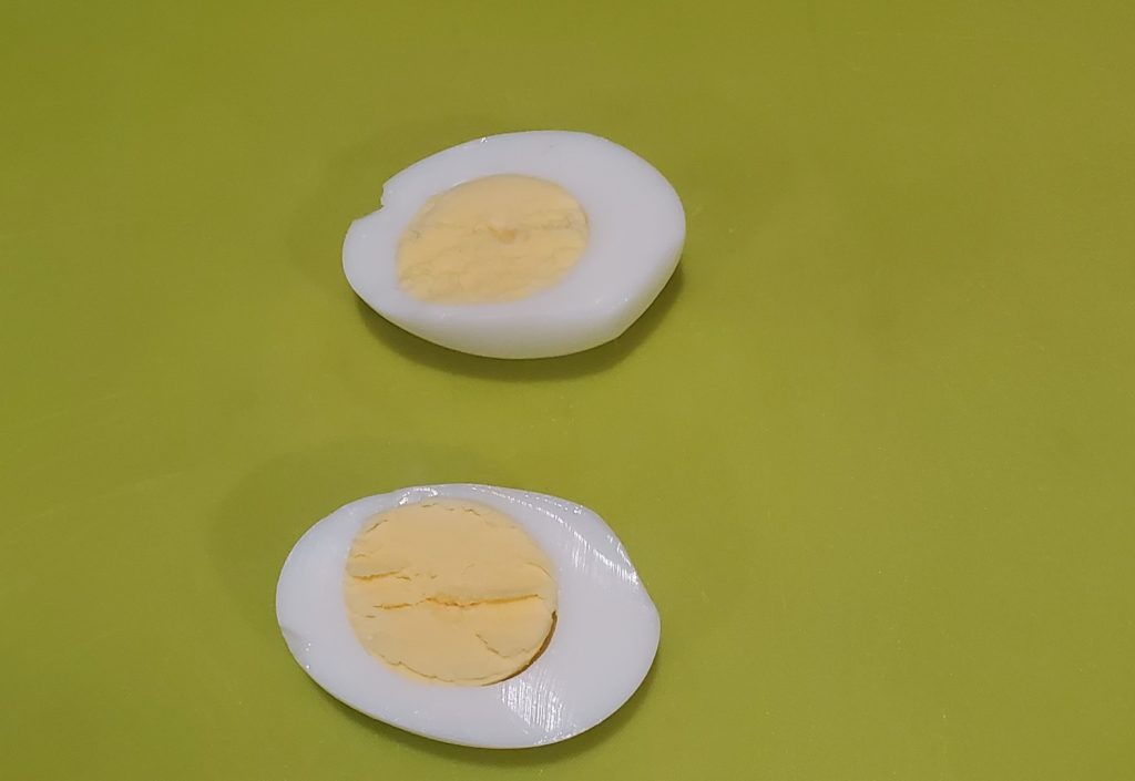 A sliced boiled egg to use for deviled eggs
