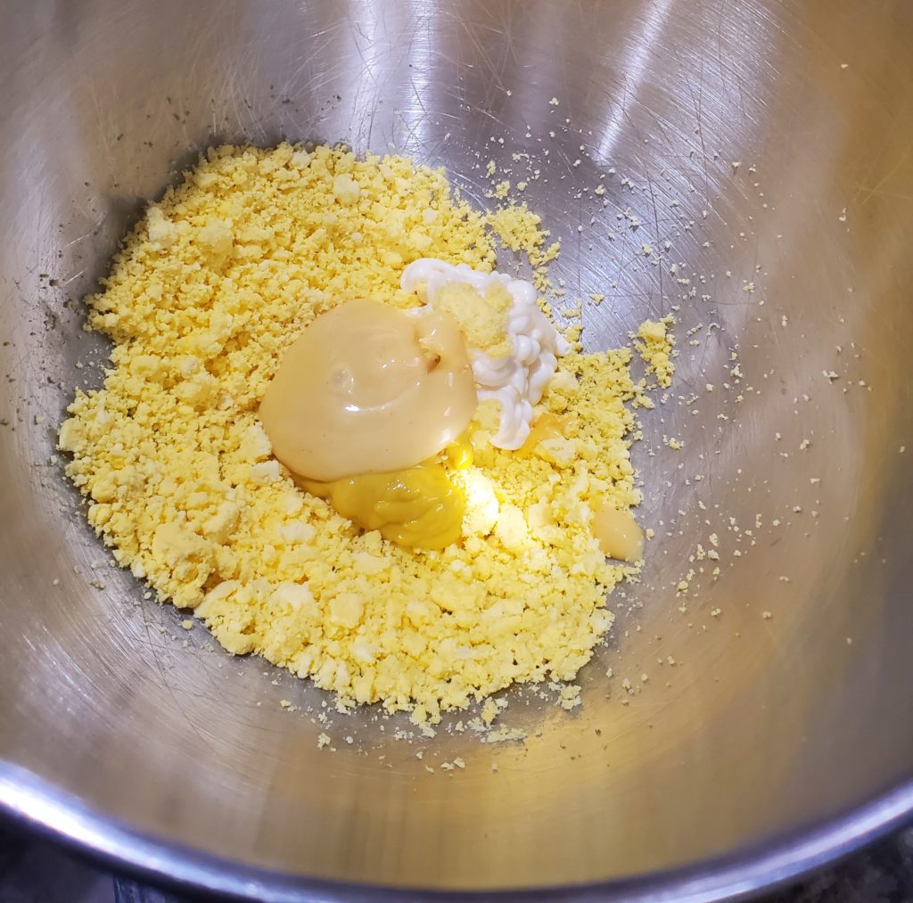 The mashed egg yolks and other ingredients ready to be mixed for this deviled egg recipe