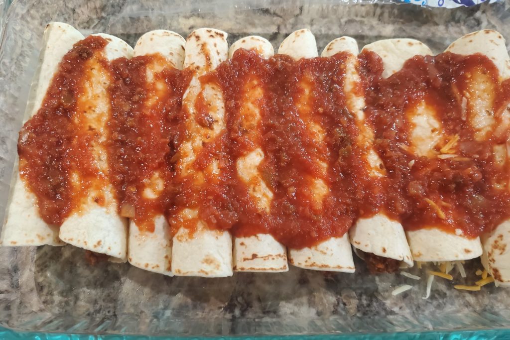 Enchiladas topped with salsa