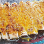 Cooked beef enchiladas in a glass baking dish