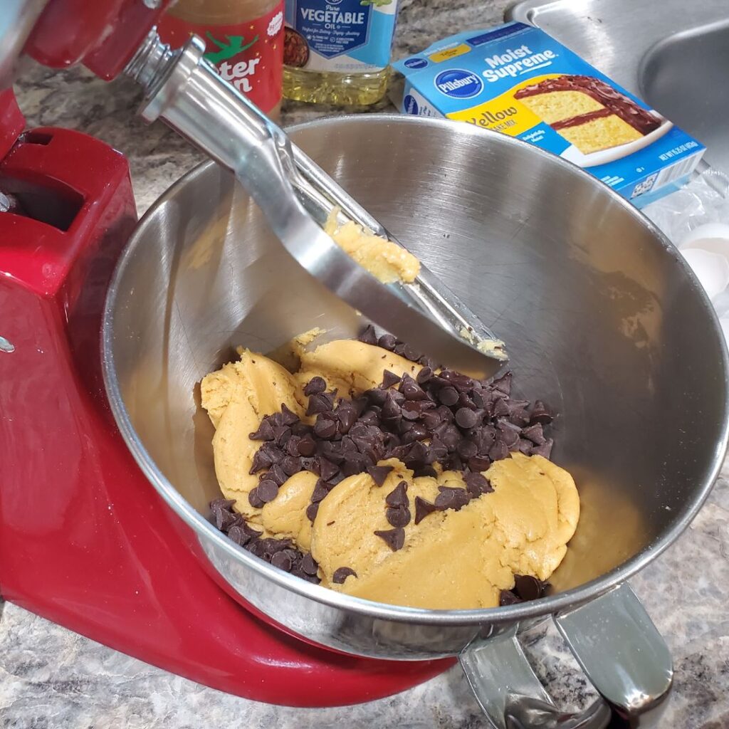 Adding the chocolate chips into the peanut butter chocolate chip cookie bars