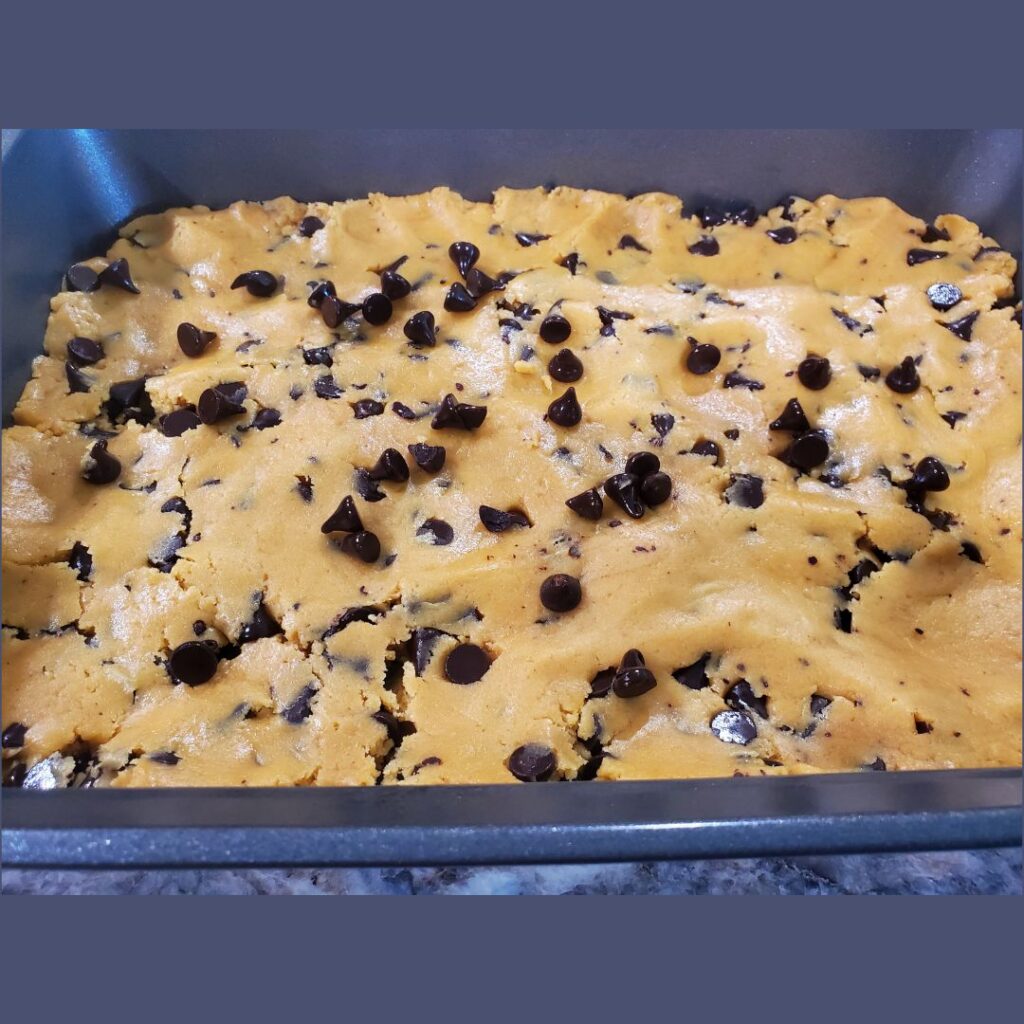 Peanut butter chocolate chip cookie bars in the pan