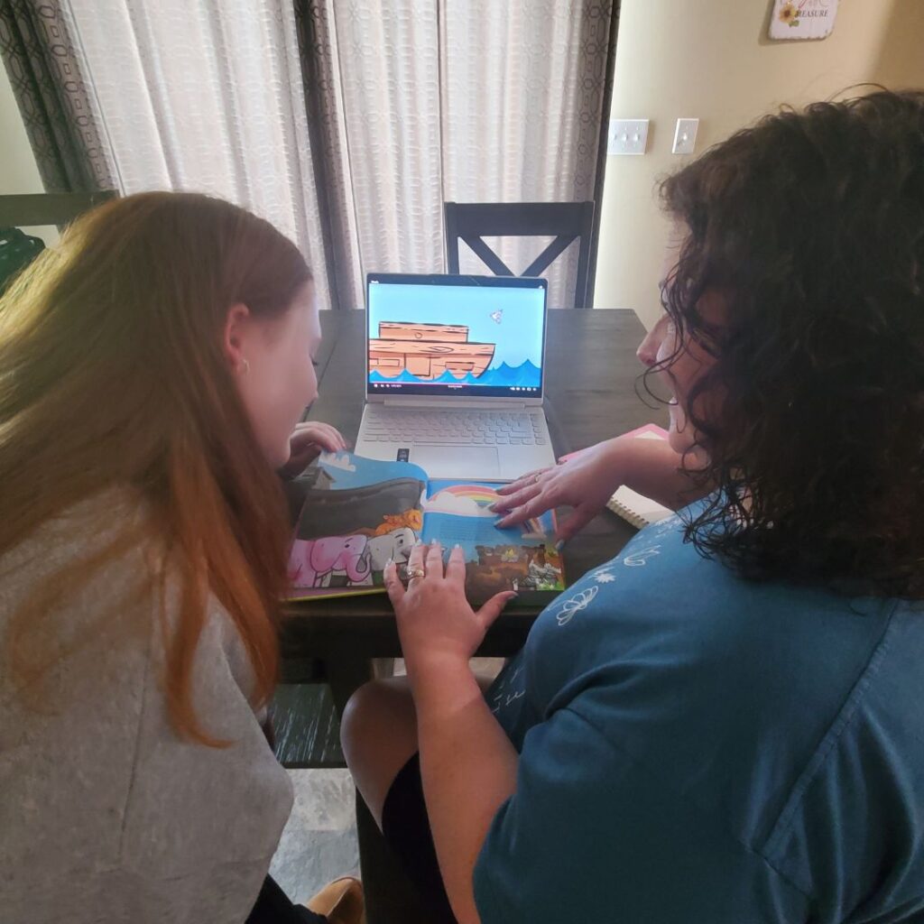 A photo of my daughter and me lesson prepping for preschool with the "Hey-O! Stories of the Bible"